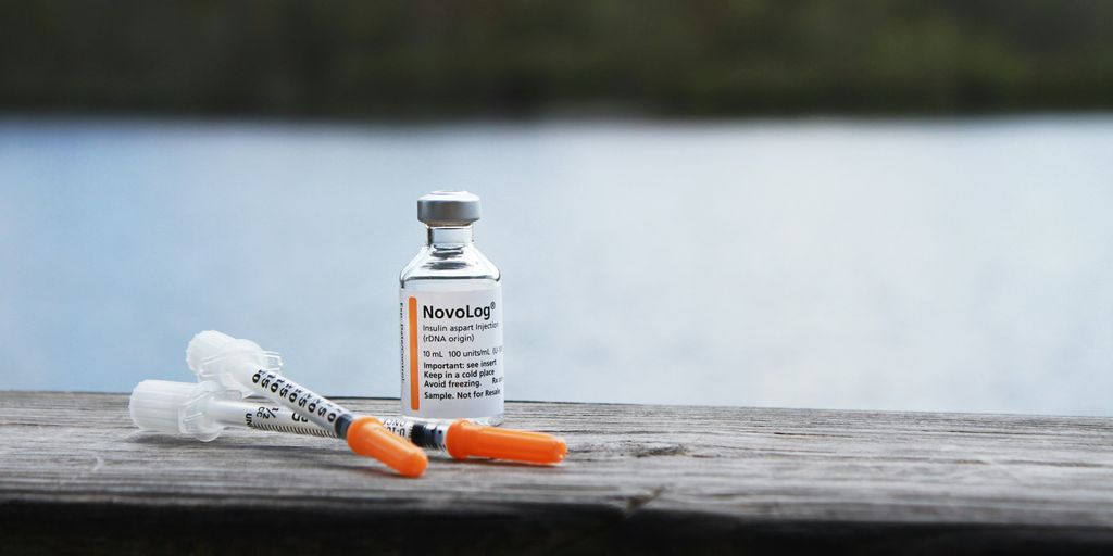 orange and white plastic bottle on brown wooden table