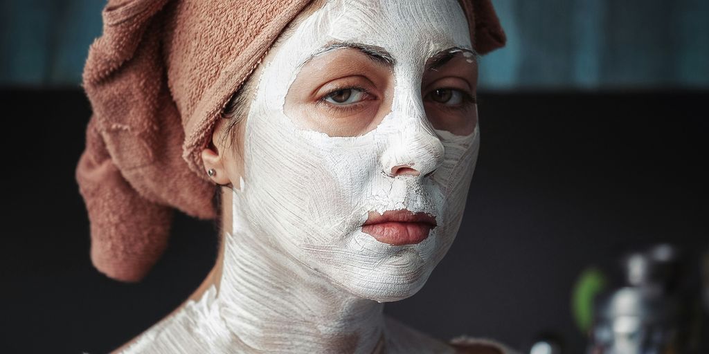 shallow focus photography of woman having a facial