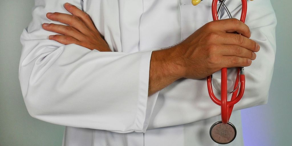 doctor holding red stethoscope