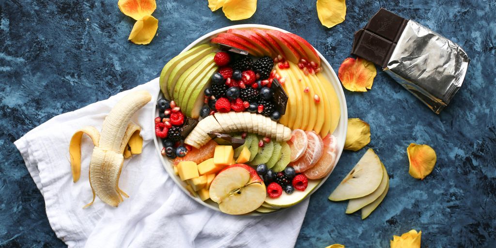 bowl of sliced fruits on white textile