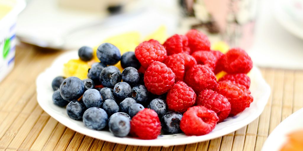 strawberries and blue berries on palte